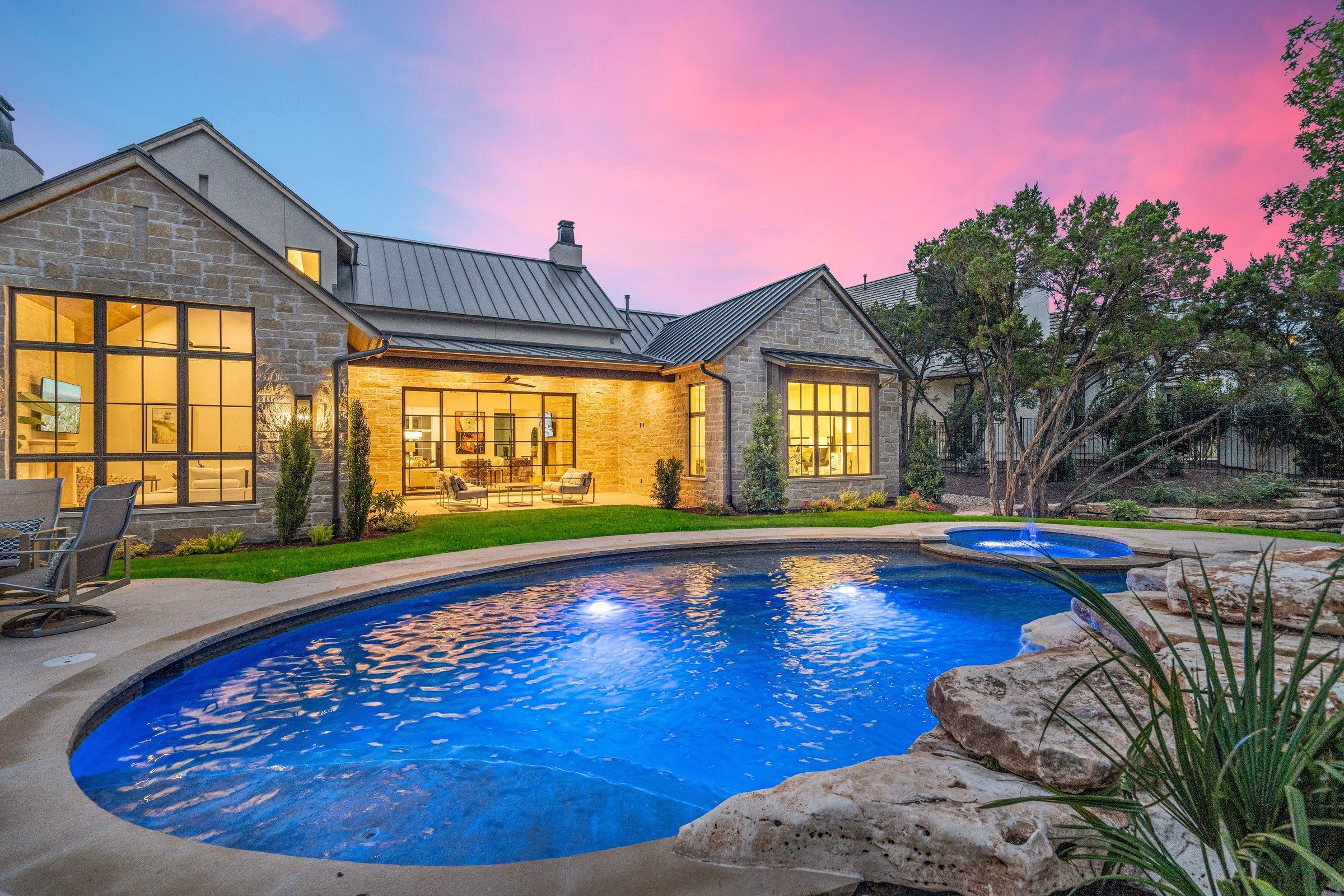 Pool and rear elevation at 4300 Amarra Drive at twilight