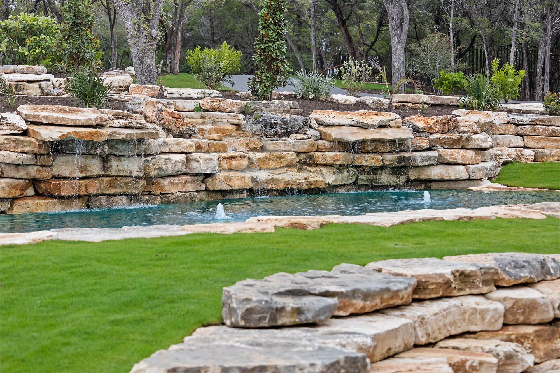 Stone waterfall and landscape arrival at 8211 Valerio